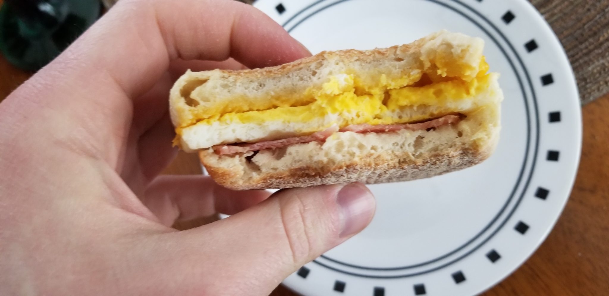 Jimmy Dean English Muffin, Canadian Bacon, Whole Egg and Cheese with two bites from the front