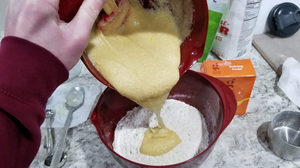 pouring chocolate chip cookie mixture