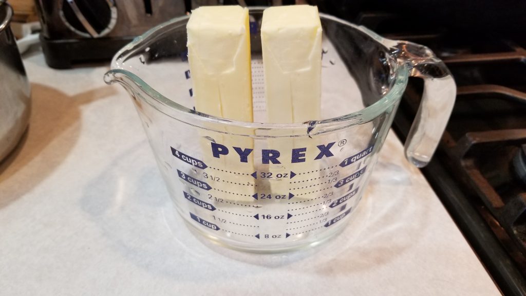butter in measuring cup for sugar cookie recipe