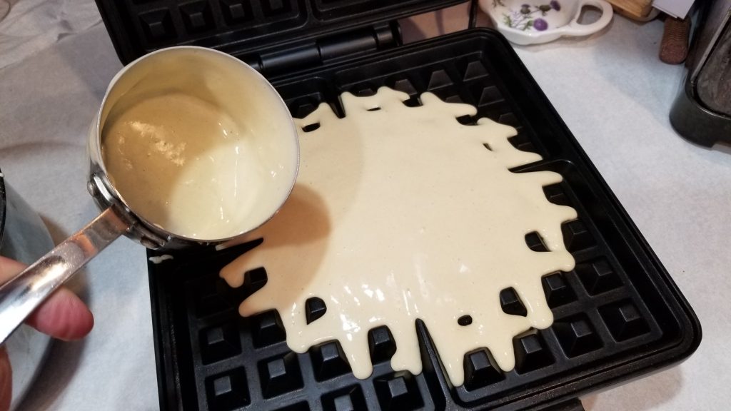 dumping waffle batter