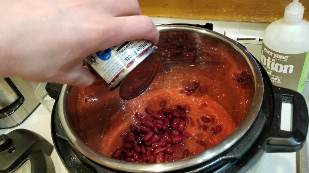 pouring beans into instant pot for chili