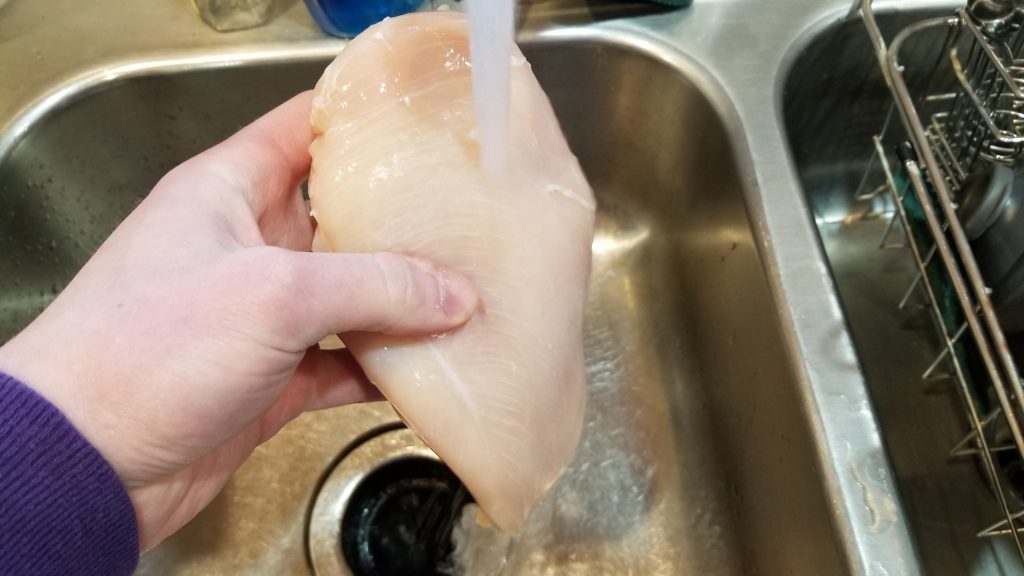 chicken being washed