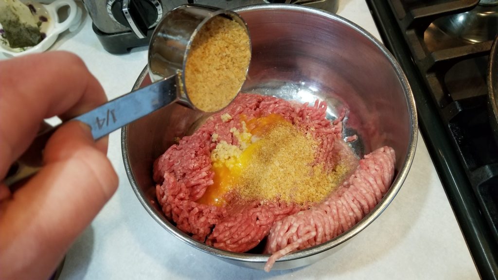dumping breadcrumbs for meatball recipe