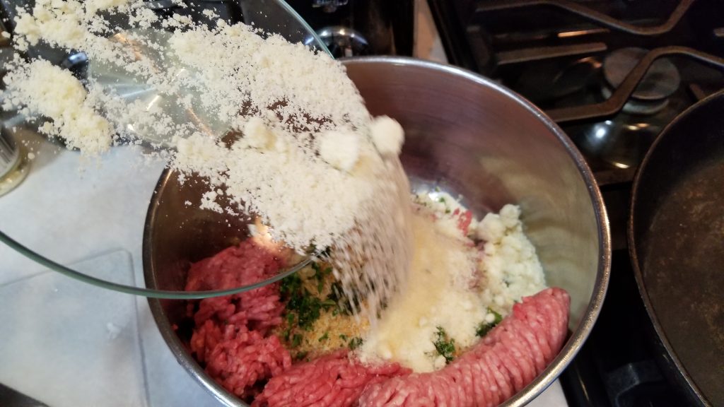 dumping cheese in bowl for meatball recipe