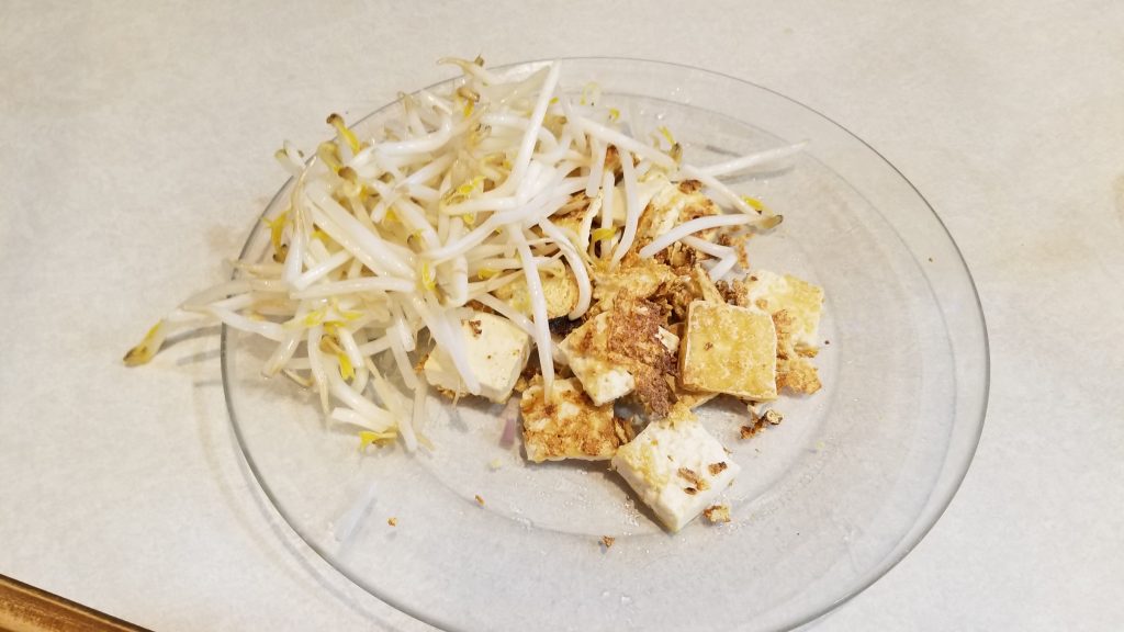tofu and bean sprouts on a plate for fried rice recipe