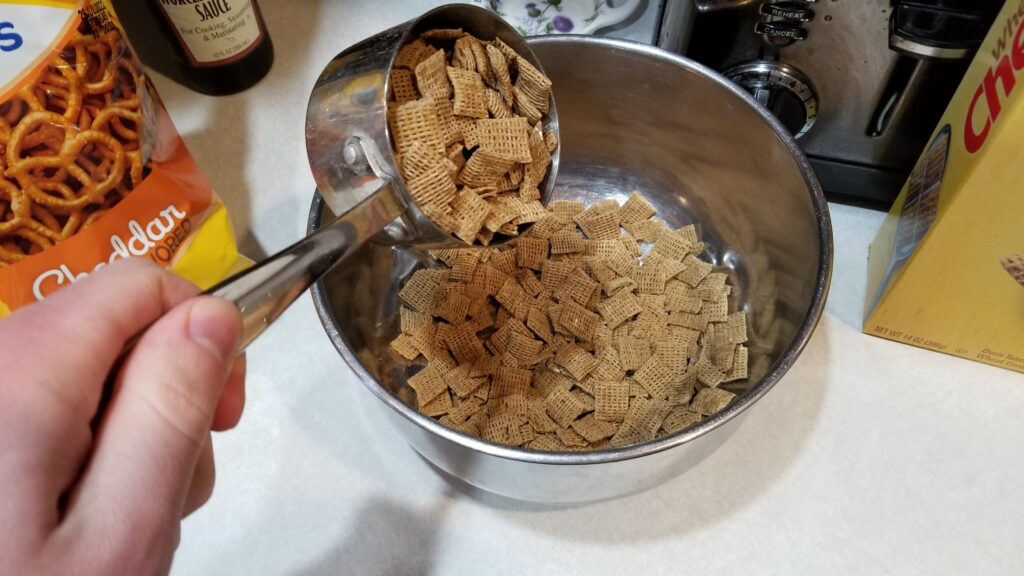 dumping cereal into chex mix recipe