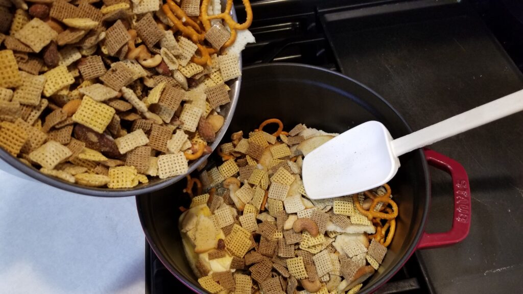 filling a pot up with chex mix