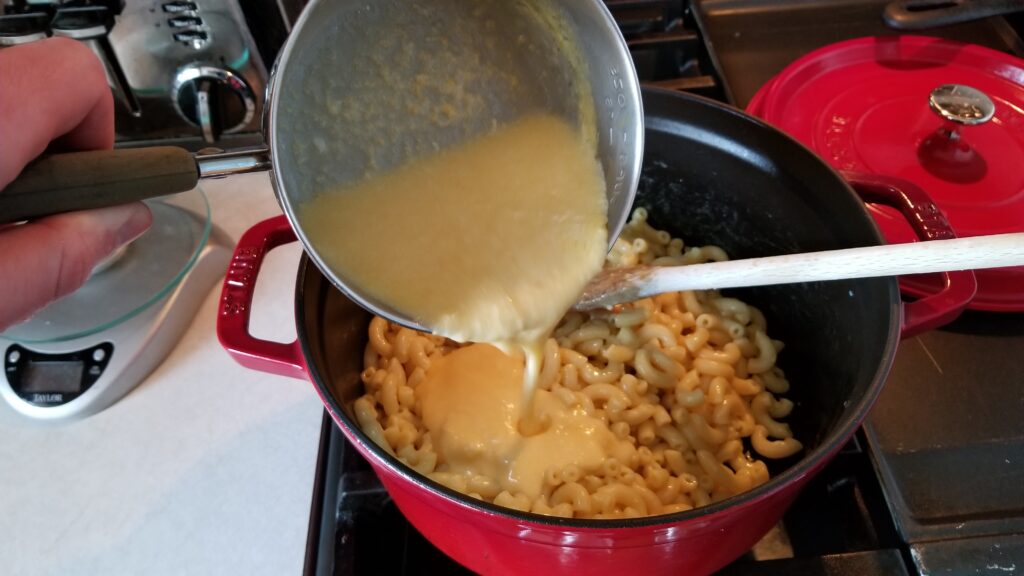 pouring cheese for mac and cheese recipe