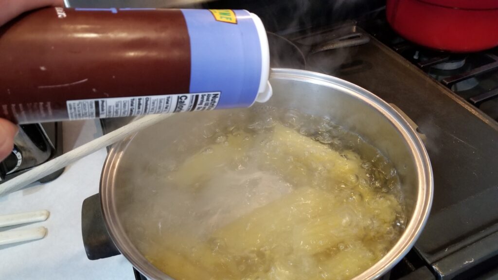 adding salt to pasta