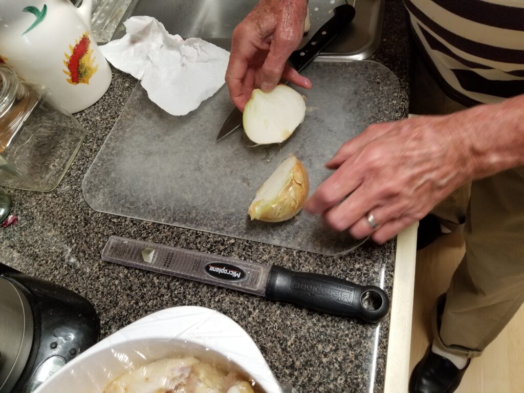 cutting onion in half for risotto recipe