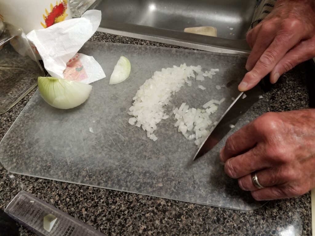 chopping onion for risotto recipe