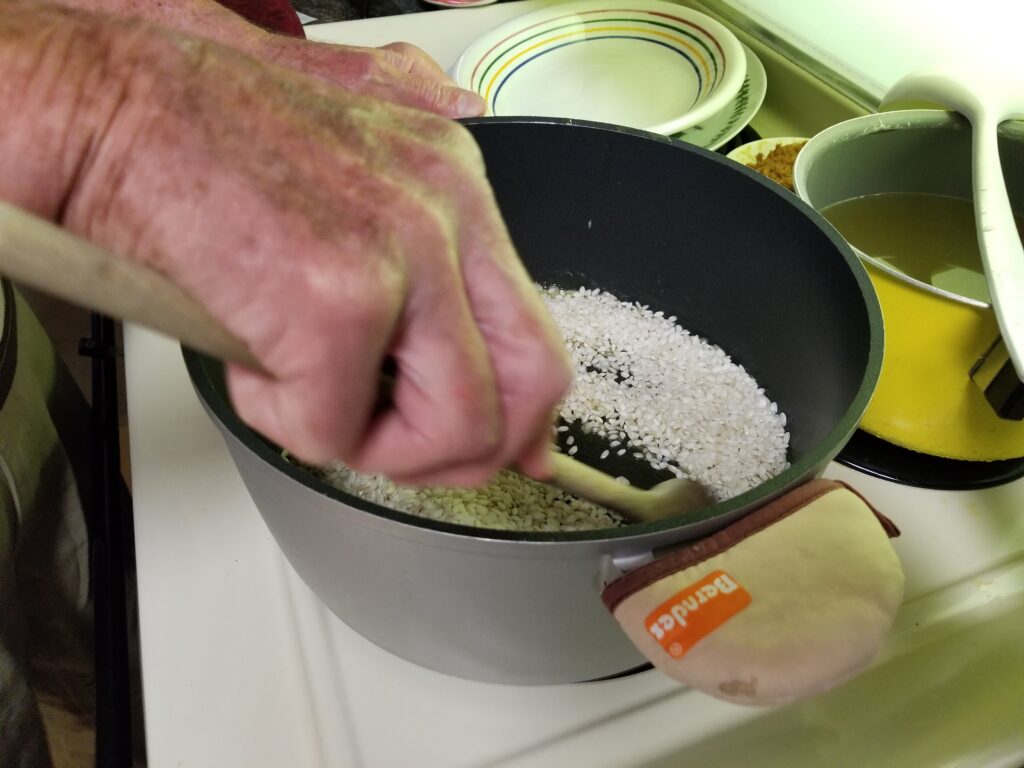 dumping rice for risotto into pot