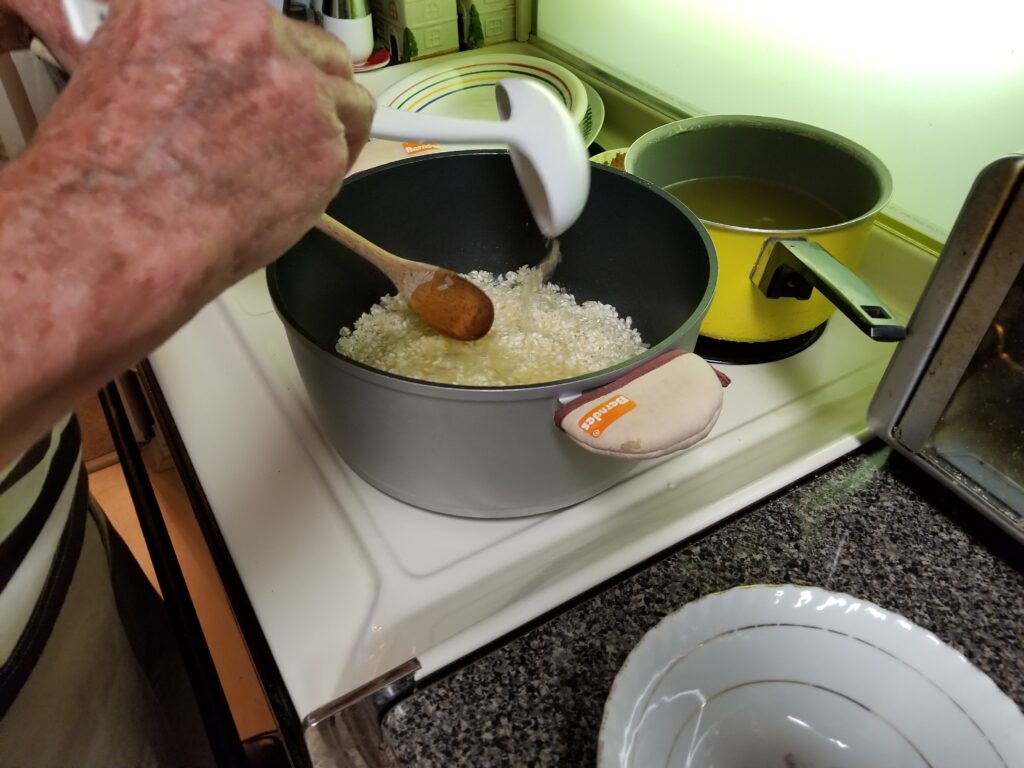 pouring broth into rice