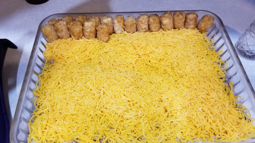 lining tater tots on glass baking dish for tater tot casserole
