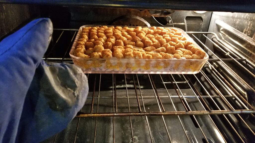tater tot casserole coming out of the oven