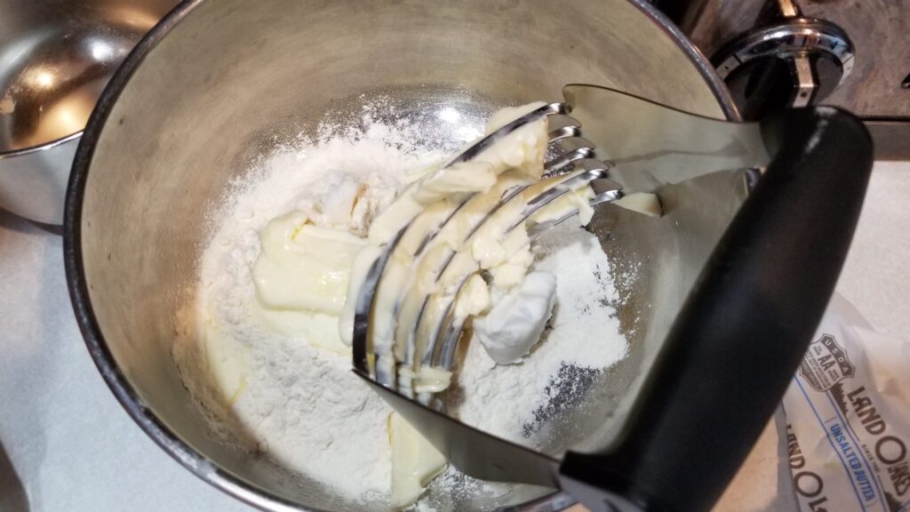 cutting up butter for pie crust recipe