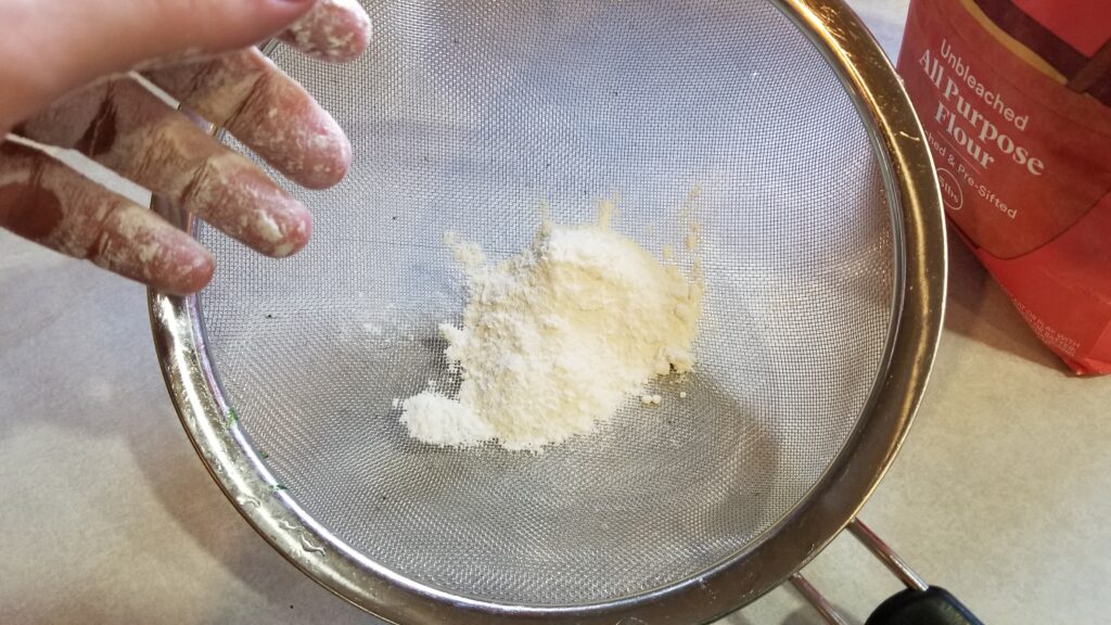 flour in mesh strainer