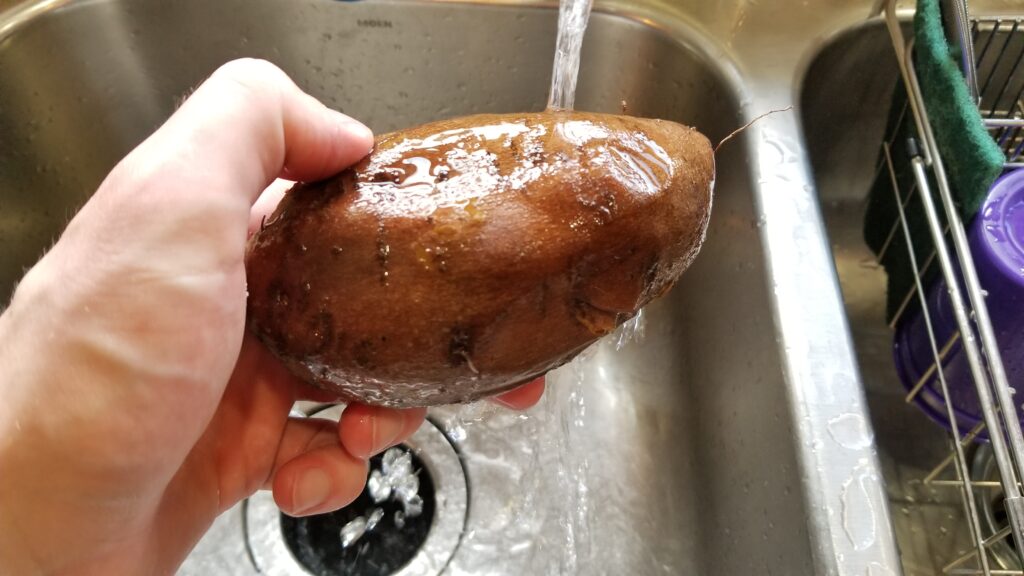running potato under cold water