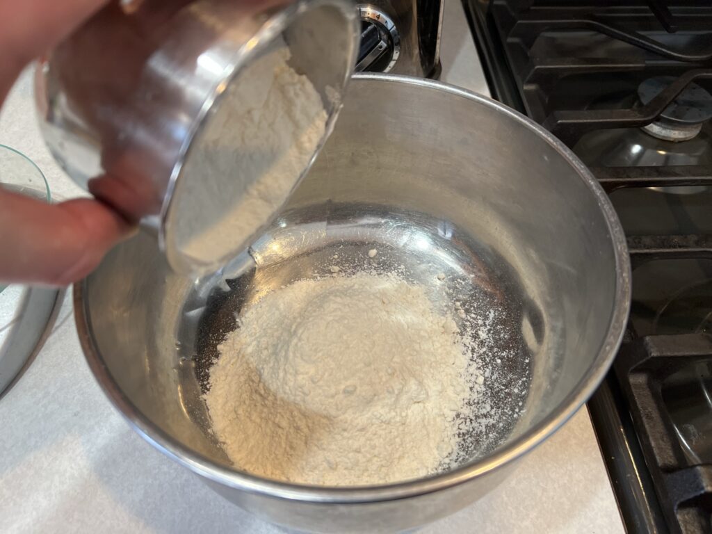 dumping flour into bowl