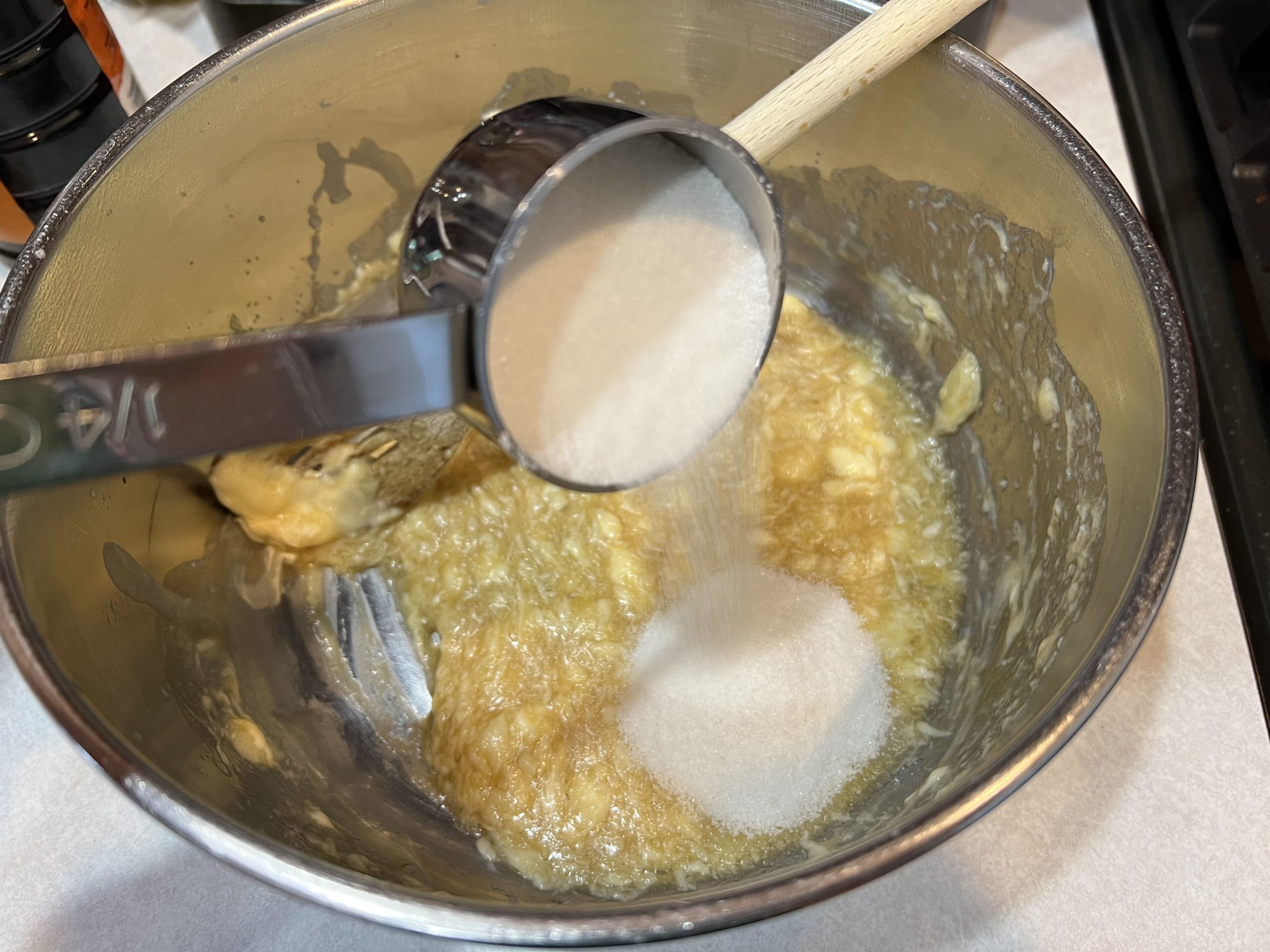 pouring sugar into large bowl