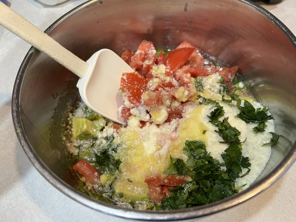 mixing gemelli pasta salad ingredients