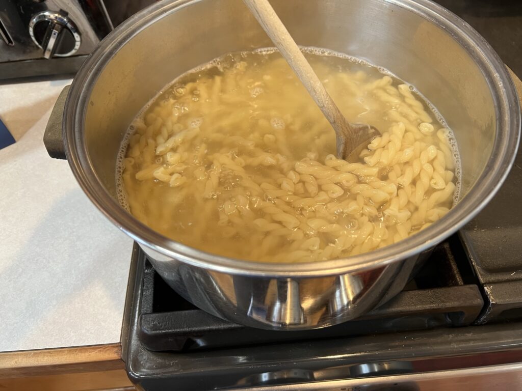 mixing gemelli pasta