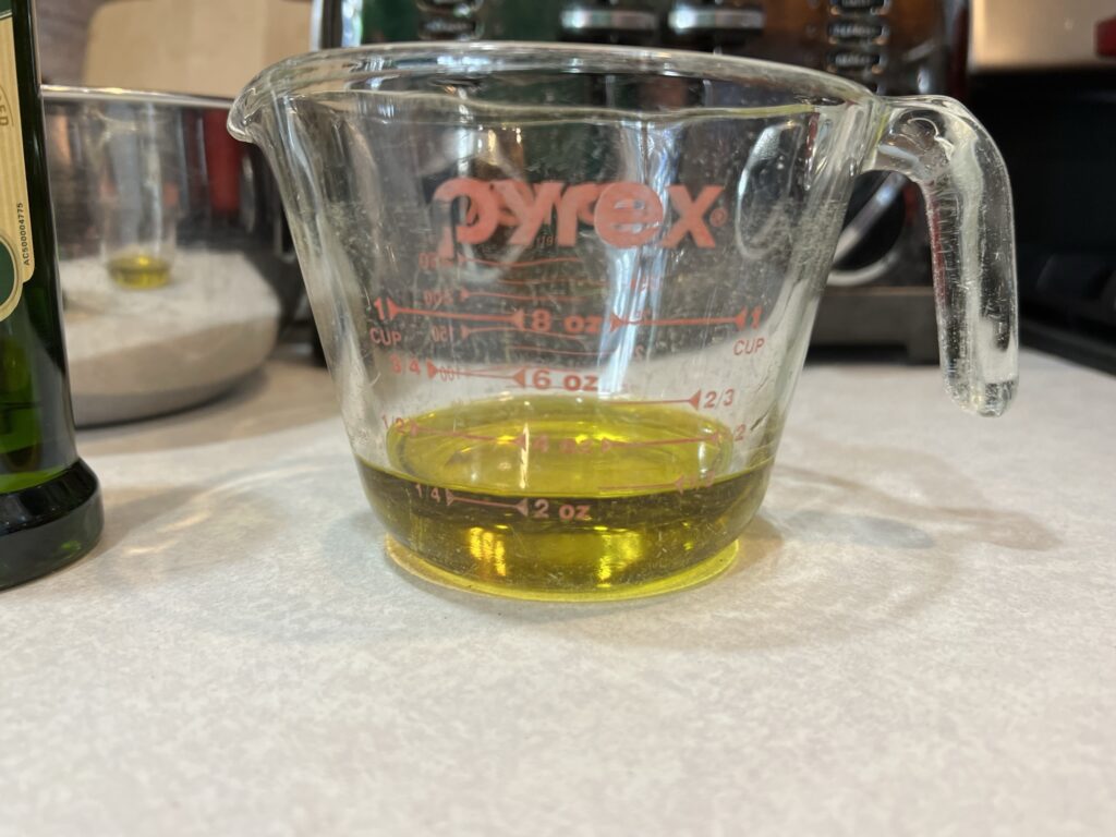 olive oil in measuring cup for Tagliolini